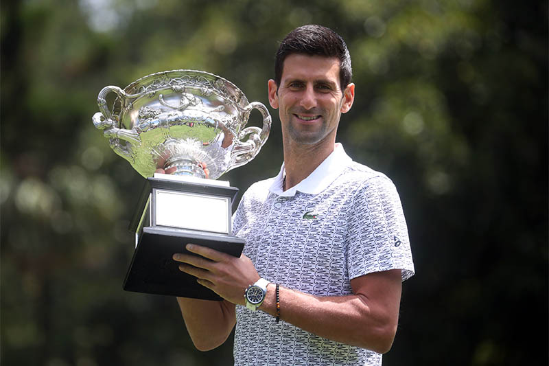 Australian Open champion Serbia's Novak Djokovic poses with the trophy during a photo shoot at the Royal Botanic Gardens Victoria. Photo: Reuters