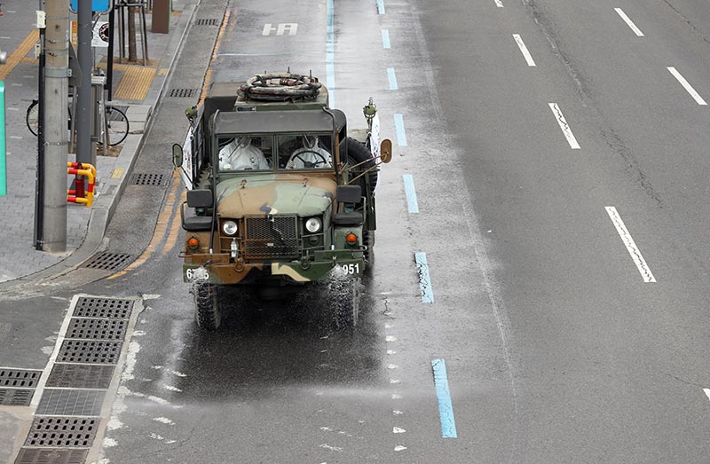 A military vehicle disinfects a street in Daegu, South Korea, February 27, 2020. Photo: Yonhap via Reuters
