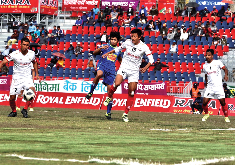 Action in the match between Jhapa-XI Football Club (centre) and Nepal APF Club during the 18th Aaha-Rara Gold Cup at the Pokhara Stadium in Kaski on Friday. Photo Courtesy: Sudarshan Ranjit