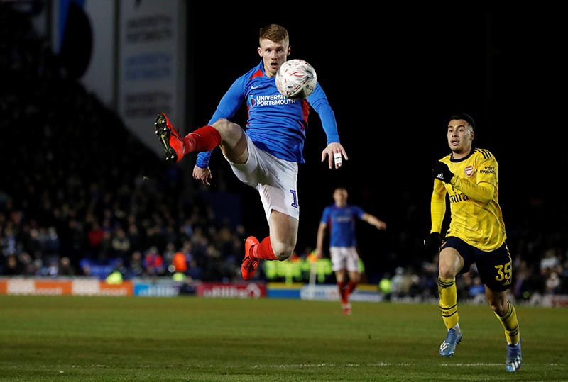 Arsenal's Gabriel Martinelli in action with Portsmouth's Andrew Cannon during the FA Cup Fifth Round match between Portsmouth and Arsenal, at Fratton Park, in Portsmouth, Britain, on  March 2, 2020. Photo: Reuters