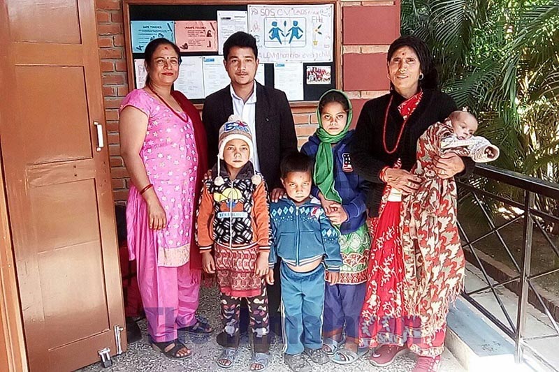 Staffers at SOS Children's Village, Lumbini, along with the children pose for a photograph, on March 14, 2020. The organisation took in the children u2014 residents of Jagannath Rural Municipality-6 in Bajura district u2014  who were left without their mother. Photo: Prakash Singh/THT
