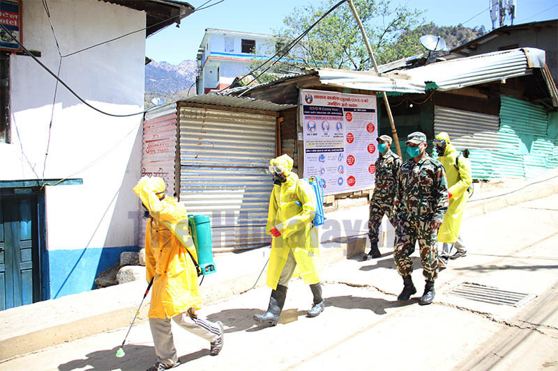 Army personnel spraying disinfectant in marketplace at Martardi, district headquarters of Bajura, during the lockdown amid concerns of COVID-19 outbreak, on Sunday, March 29, 2020. Photo: Prakash Singh