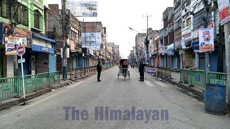 Security personnel are seen alongside a rickshaw in a deserted road after the government of Nepal reinforced the lockdown measures to combat the coronavirus disease (COVID-19) in Adarshanagar Chok, Birgunj Metropolitan City, Parsa district, on Tuesday, March 24, 2020. Photo: Ram Sarraf/THT
