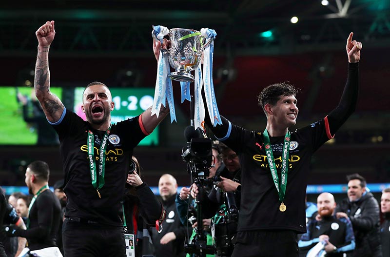 Manchester City's John Stones and Kyle Walker pose with the trophy as they celebrate after winning the  Carabao Cup Final match between Aston Villa and Manchester City, at Wembley Stadium, in London, Britain, on March 1, 2020. Photo: Action Images via Reuters