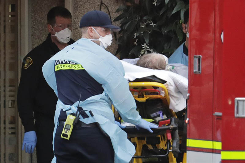 A patient is loaded into an ambulance, Tuesday, March 10, 2020, at the Life Care Center in Kirkland, Wash., near Seattle. The nursing home is at the center of the outbreak of the coronavirus in Washington state. Photo: AP