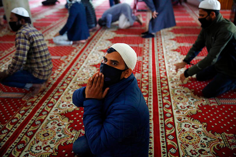 A Muslim man wears a face mask amid concerns over the spread of coronavirus infection (COVID-19) during the Friday prayers at a mosque, in Kathmandu, on March 20, 2020. Photo: Skanda Gautam/THT