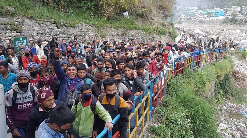 Stranded Nepali migrant workers shouting slogans on Darchula border, on Monday. Photo courtesy: Keshav Joshi