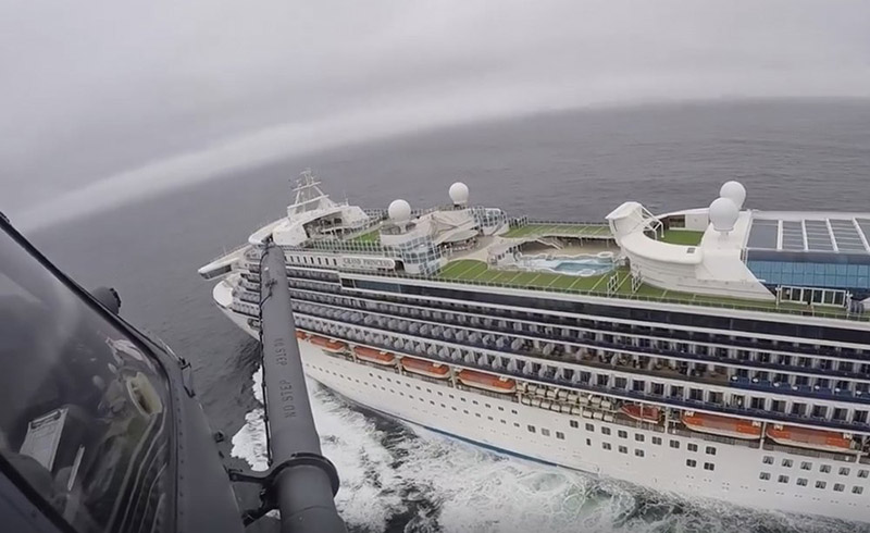 In this image from video, provided by the California National Guard, a helicopter carrying airmen with the 129th Rescue Wing flies over the Grand Princess cruise ship off the coast of California, on Thursday, March 5, 2020. Scrambling to keep the coronavirus at bay, officials ordered a cruise ship with 3,500 people aboard to stay back from the California coast Thursday until passengers and crew can be tested, after a traveller from its previous voyage died of the disease and at least two others became infected. Airmen lowered test kits onto the 951-foot (290-metre) Grand Princess by rope as the vessel lay at anchor off Northern California, and authorities said the results would be available on Friday. Princess Cruise Lines said fewer than 100 people aboard had been identified for testing. Photo: California National Guard via AP