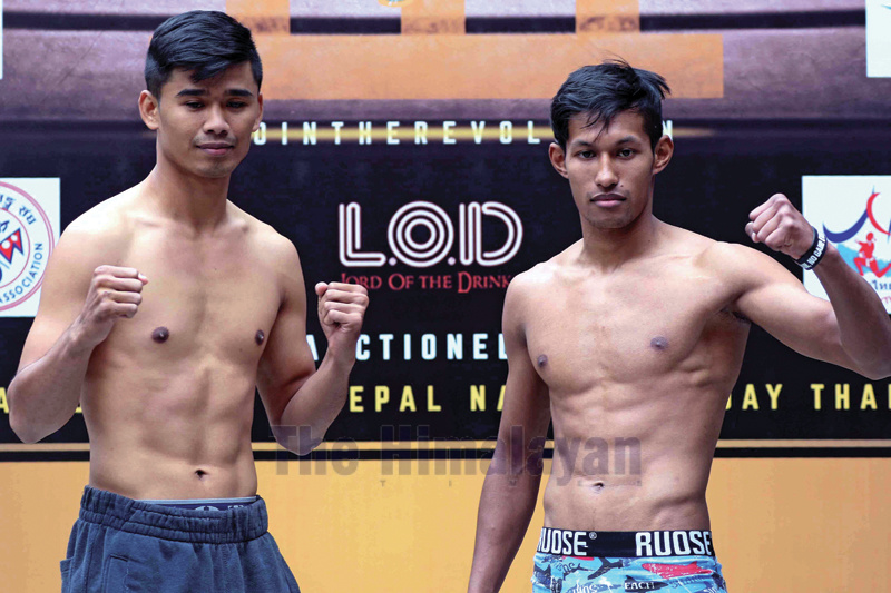 Karan Bajracharya (right) and Faphayao Sorsorjeeradech of Thailand pose while facing off Muyathai fight main event fight during press meet and weighing of Gymkhana Fight Night at Lazimpat in Kathmandu on Friday. Photo: Udipt Singh Chhetry/THT
