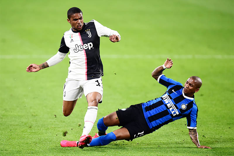 Juventus' Douglas Costa in action with Inter Milan's Ashley Young. Photo: Reuters