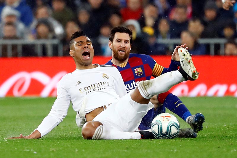 Real Madrid's Casemiro is fouled by Barcelona's Lionel Messi during their La Liga Santander match at Santiago Bernabeu, in Madrid, Spain, at March 1, 2020. Photo: Rueters