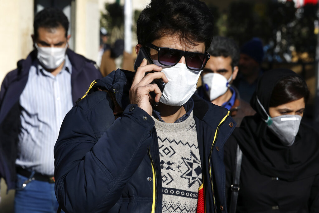 FILE - In this Monday, March 2, 2020 file photo, a man wearing a face mask, to help protect against the new coronavirus, speaks on his cellphone in downtown Tehran, Iran. Local media reported Thursday, March 26, 2020, that nearly 300 people have been killed and more than 1,000 sickened by ingesting toxic methanol across the Islamic Republic out of the false belief it kills the new coronavirus. Photo: AP