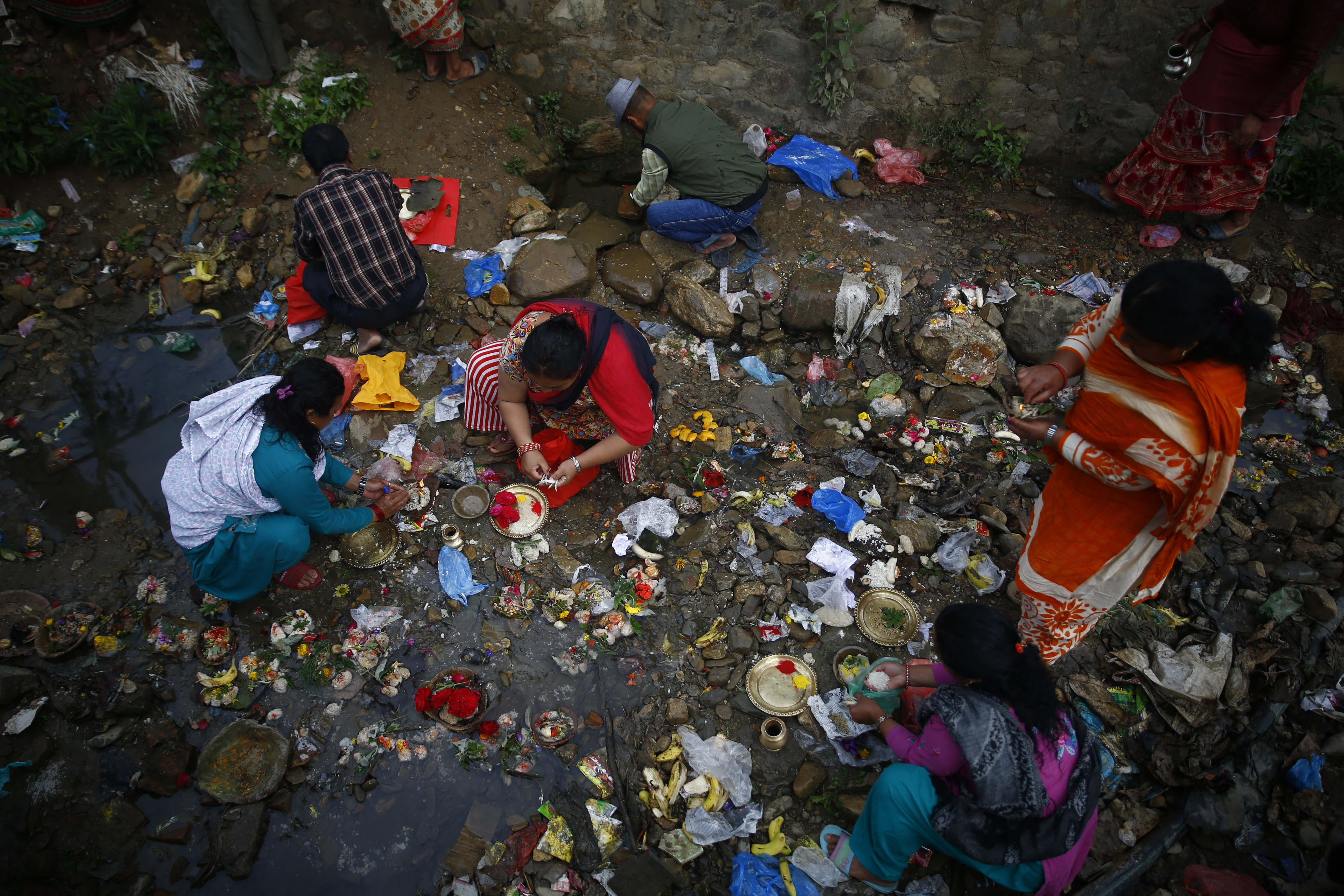 Devotees gather at Mata Tirtha pond to pray in memory of their deceased mothers, with a belief that taking a holy bath will help their mothers reach salvation and bring prosperity to families, on Mother's Day, during a government-imposed nationwide lockdown, as a preventive measure against the spread of COVID-19, in Kathmandu, on Thursday, April 23, 2020. Photo: Skanda Gautam/THT