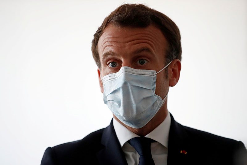 French President Emmanuel Macron, wearing a protective face mask, talks with health workers as he visits a medical center in Pantin near Paris as the spread of the coronavirus disease (COVID-19) continues in France, on April 7, 2020. Photo: Reuters