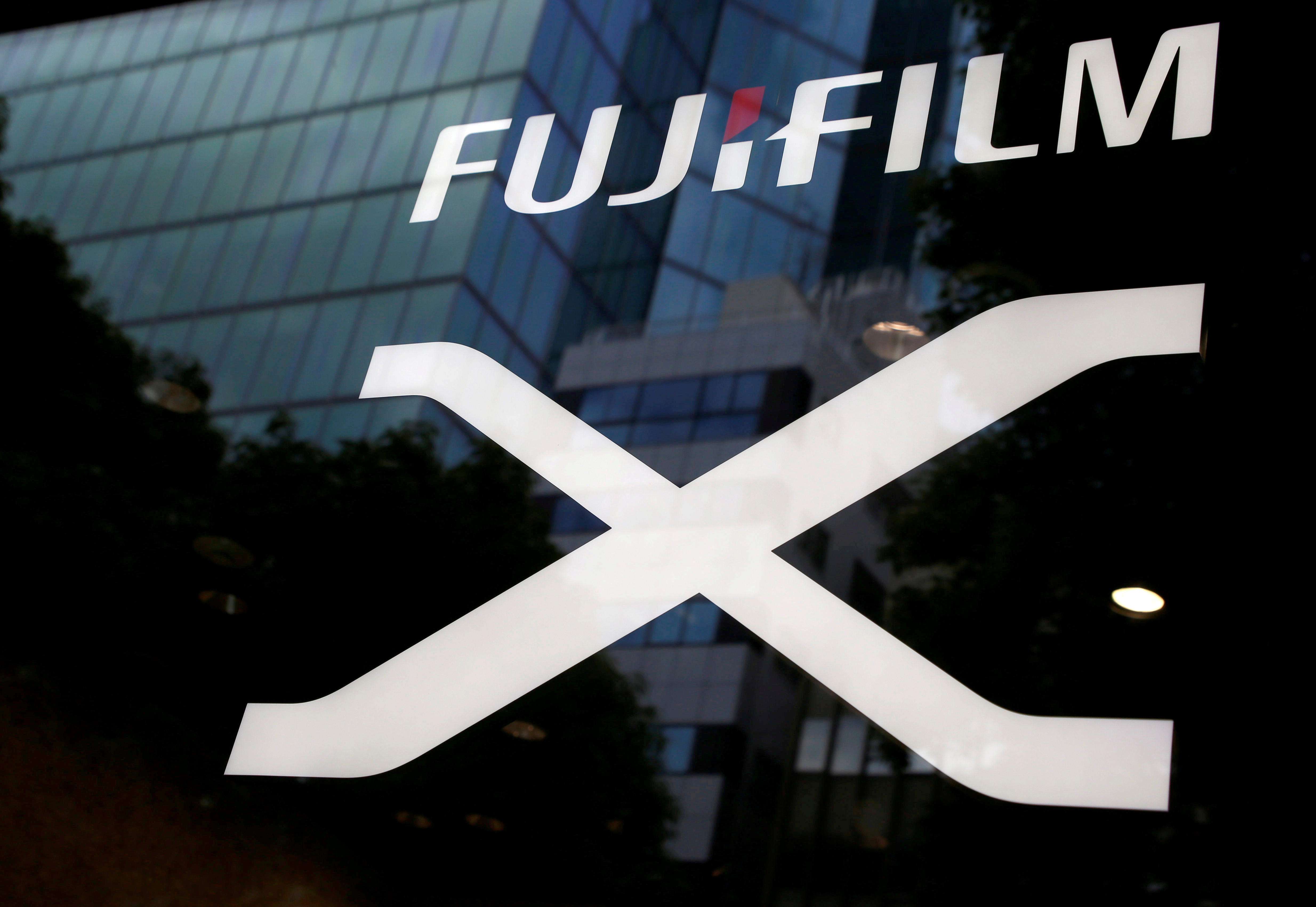 FILE PHOTO: Fujifilm's company logo (top) is seen at its exhibition hall nearby the headquarters of Fujifilm Holdings Corp in Tokyo, Japan June 12, 2017. REUTERS/Kim Kyung-Hoon/File Photo