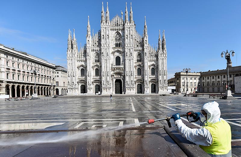 FILE - A worker wearing protective garments sanitises the Duomo square, during the coronavirus disease (COVID-19) outbreak in central Milan, Italy March 31, 2020. Photo: Reuters