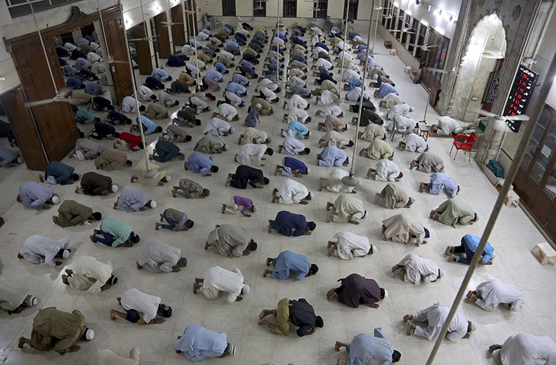 FILE - People attend evening prayers while maintaining a level of social distancing to help avoid the spread of the coronavirus, at a mosque in Karachi, Pakistan, on  Sunday, April 19, 2020.  Photo: AP