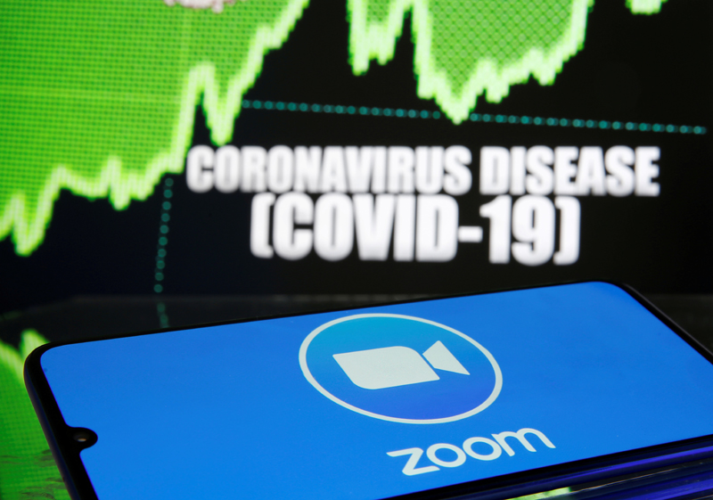 Zoom logo is seen in front of diplayed coronavirus disease (COVID-19) in this illustration taken March 19, 2020. Photo: Reuters/File