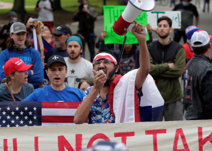Protesters rally at the Texas State Capitol to speak out against Texas' handling of the COVID-19 outbreak, in Austin, Texas, Saturday, April 18, 2020. Austin and many other Texas cities remain under stay-at-home orders due to the COVID-19 outbreak except for essential personal. Photo: AP