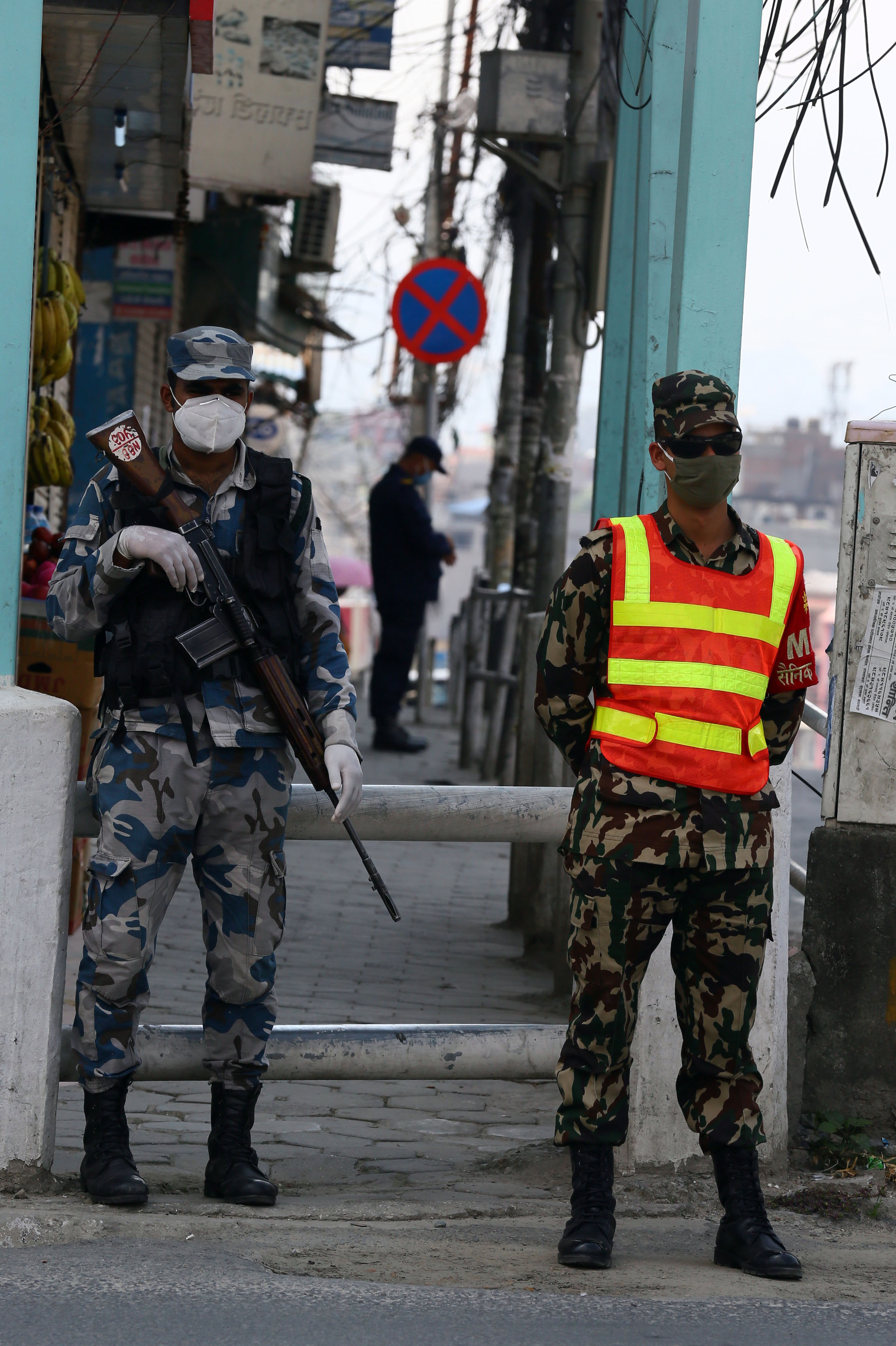 Security personnel guarding the streets of Narayan Gopal Chowk, Kathmandu, to restrict vehicular and pedestrian movement during the COVID-19 lockdown, on Sunday. Photo: Rajesh Gurung/THT