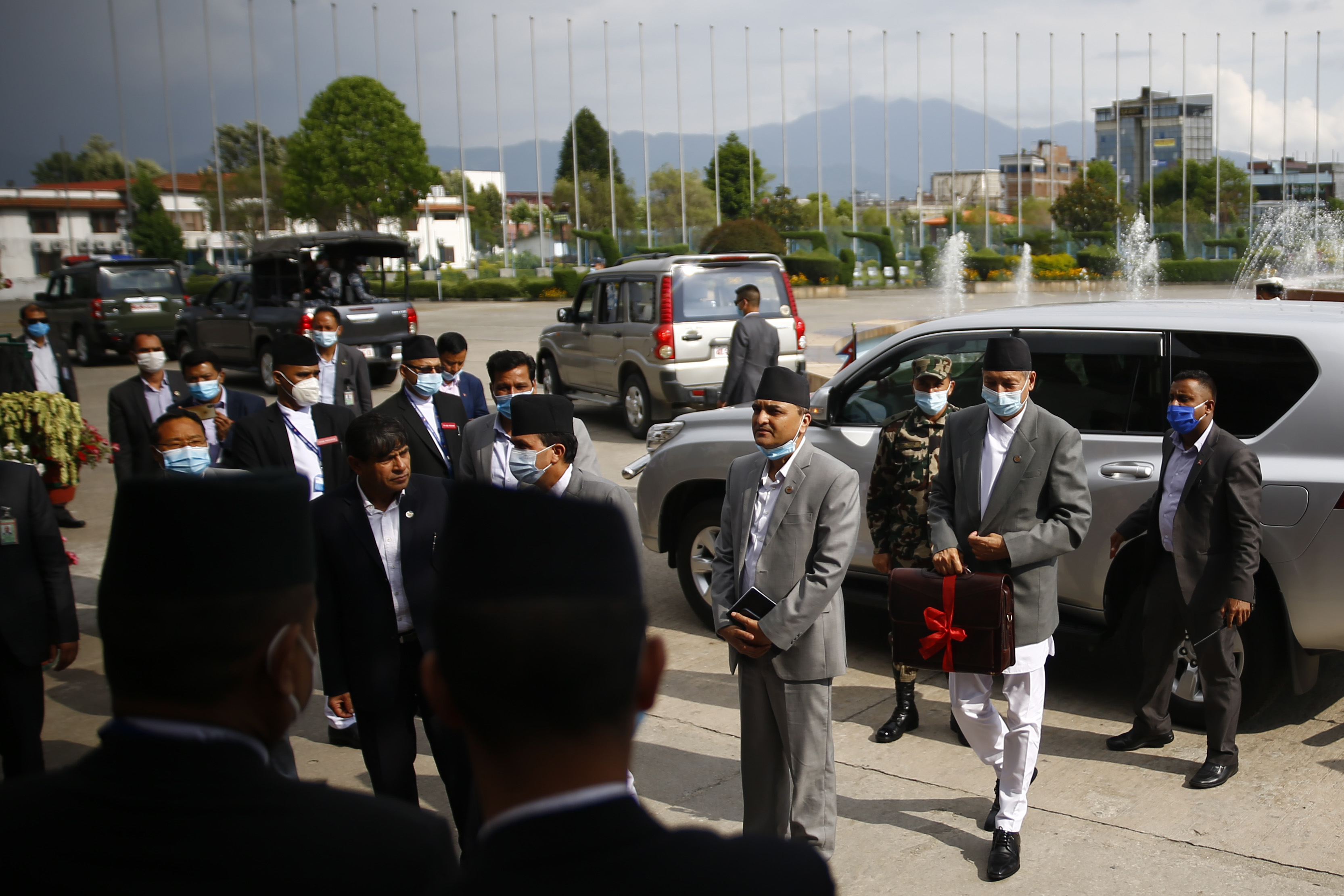 Finance Minister Yubaraj Khatiwada carries a briefcase with the new government's budget for fiscal of 2020-21 at the joint meeting of House of Representatives and the National Assembly at Federal Parliament in Kathmandu, Nepal on Thursday, May 28, 2020.