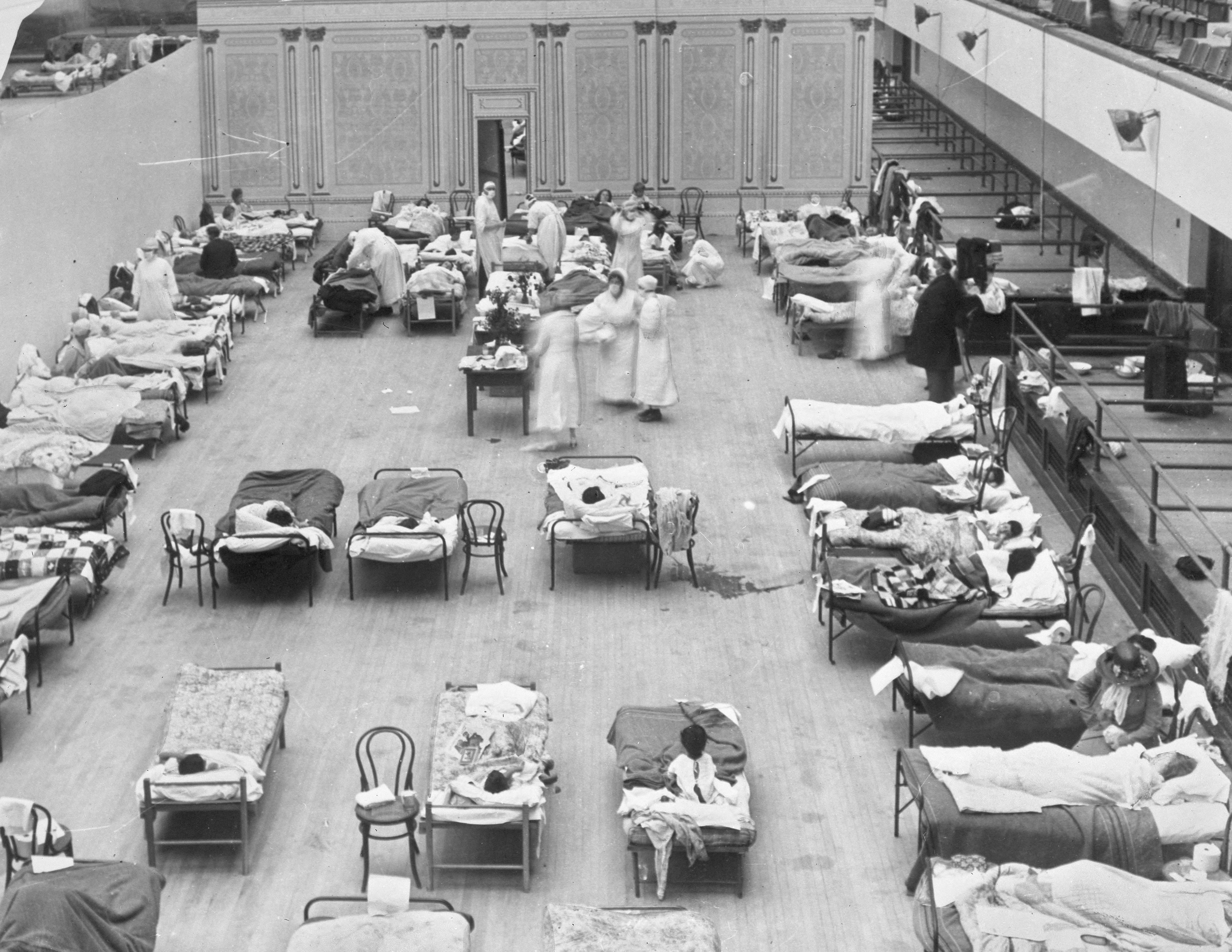 FILE - In this 1918 file photo made available by the Library of Congress, volunteer nurses from the American Red Cross tend to influenza patients in the Oakland Municipal Auditorium, used as a temporary hospital. Science has ticked off some major accomplishments over the last century. The world learned about viruses, cured various diseases, made effective vaccines, developed instant communications and created elaborate public-health networks. Yet in many ways, 2020 is looking like 1918, the year the great influenza pandemic raged. Photo: AP