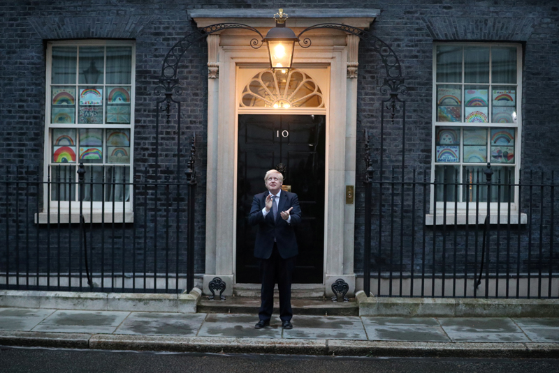 Britain's Prime Minister Boris Johnson applauds outside 10 Downing Street during the Clap for our Carers campaign in support of the NHS, following the outbreak of the coronavirus disease (COVID-19), in London, Britain, April 30, 2020. Photo: Reuters