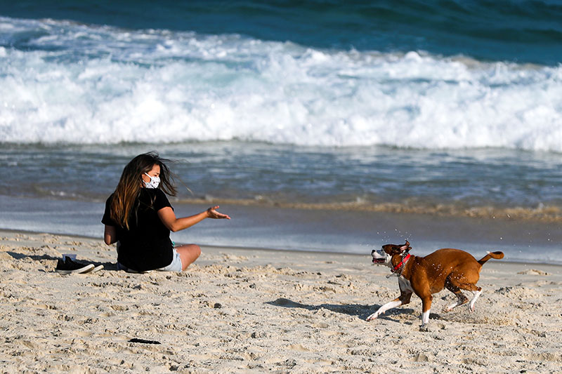 A girl plays with her dog at the Pepe beach, following the coronavirus disease (COVID-19) outbreak, in Rio de Janeiro, Brazil, on May 17, 2020. Photo: Brazil
