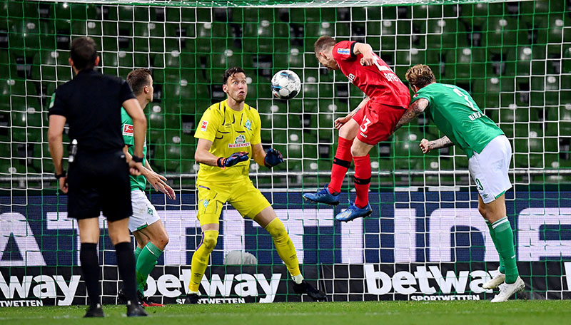 Bayer Leverkusen's Mitchell Weiser scores their third goal, as play resumes behind closed doors following the outbreak of the coronavirus disease (COVID-19) during the Bundesliga match between Werder Bremen and Bayer Leverkusen, at Weser-Stadion, in Bremen, Germany, on May 18, 2020. Photo: Stuart Franklin/Pool via Reuters