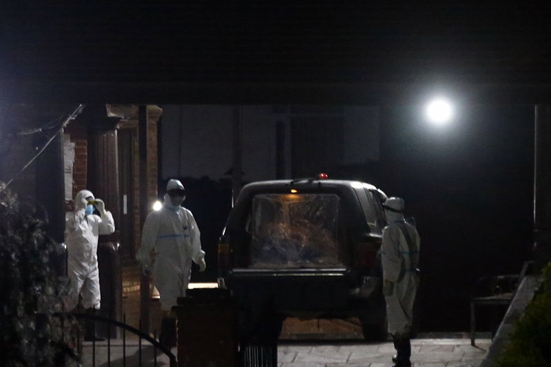 Health workers and family members stand near the van carrying the body of a deceased woman, a native of Sindhupalchowk, who succumbed to Covid-19, the first coronavirus casualty in the country, at the cremation site in Aryaghat, Kathmandu, on Saturday, May 16, 2020. Photo: Skanda Gautam / THT