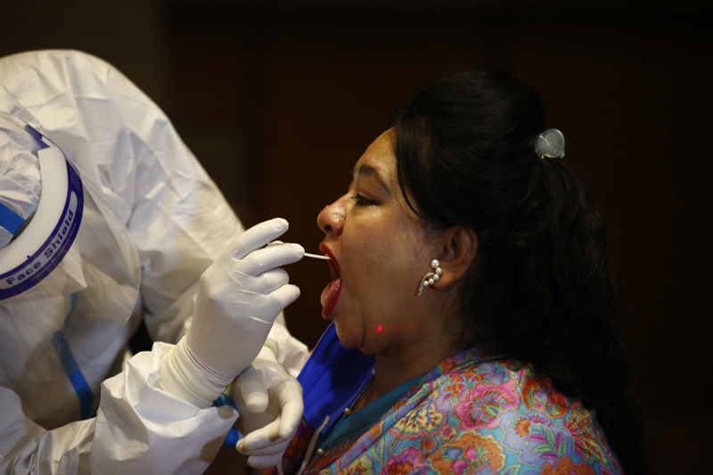 Health workers collect throat swab samples of federal lawmakers for PCR test, a day before the budget session of the federal parliament, in Kathmandu, on Thursday, May 07, 2020. Photo: Skanda Gautam/THT
