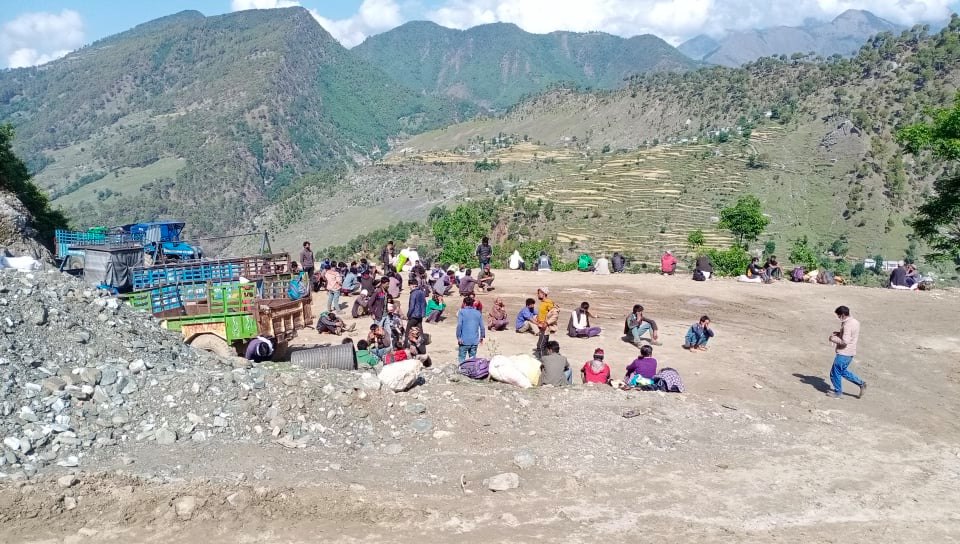 People prepare to go home after spending 35 days in quaratine in Dharchula of India, at a buspark in Martadi of Bajura district, on Saturday, May 2, 2020. Photo: Prakash Singh/THT