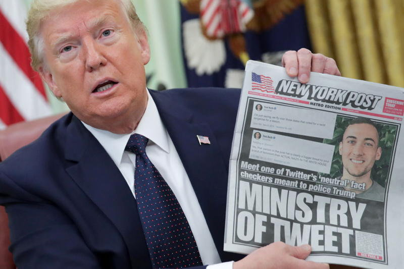 US President Donald Trump holds up a front page of the New York Post as he speaks to reporters while discussing an executive order on social media companies in the Oval Office of the White House in Washington, U.S., May 28, 2020. Photo: Reuter/File