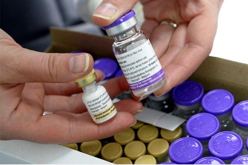 File -  A nurse holds a bottle of the Pandemrix H1N1 flu vaccine (R) and a bottle of the vaccine's adjuvant (L) at a health centre in Burgos in November 16, 2009. Photo. Reuters