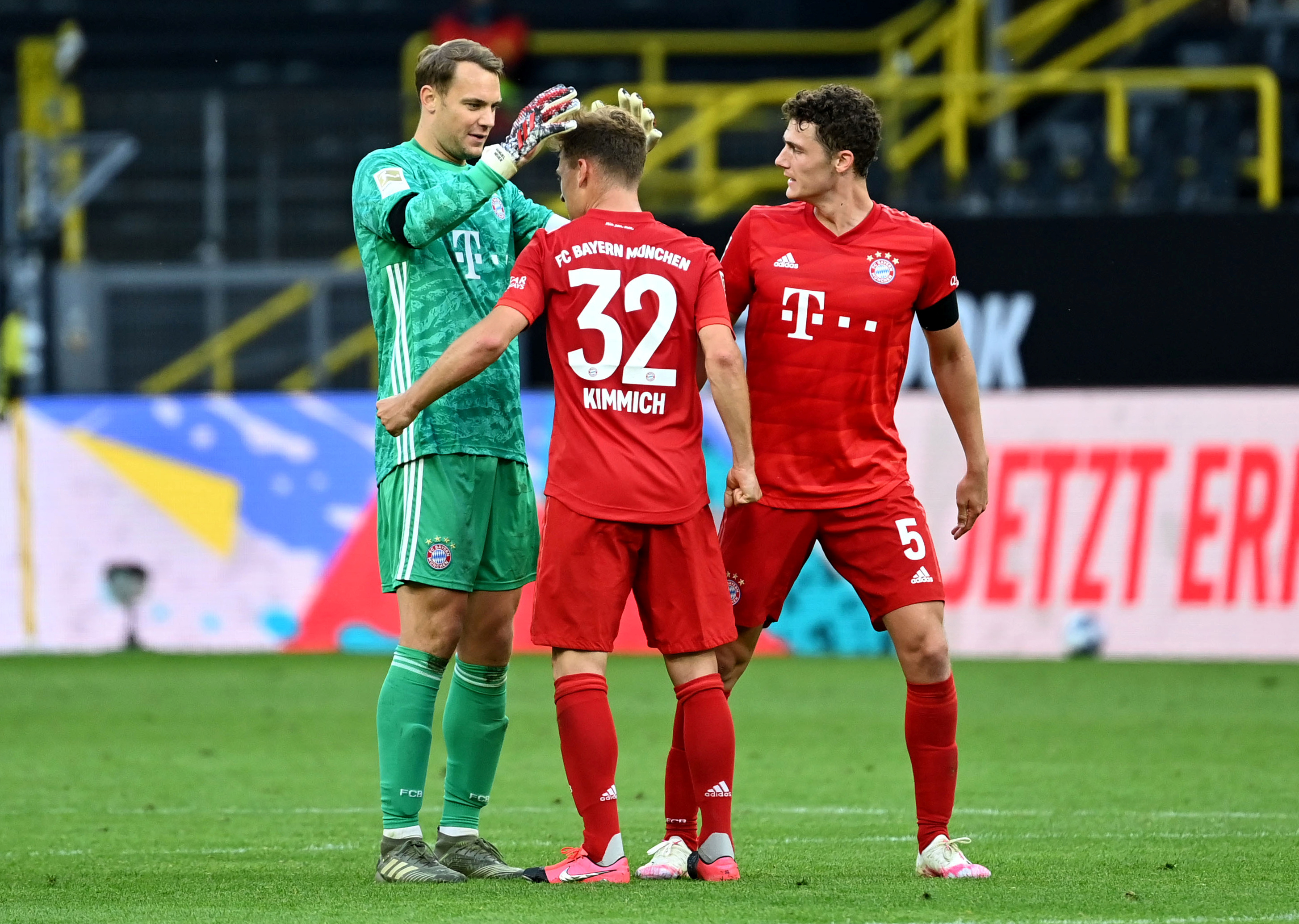 Bayern Munich's Manuel Neuer, Joshua Kimmich and Benjamin Pavard celebrates after the match, as play resumes behind closed doors following the outbreak of the coronavirus disease (COVID-19) during the Bundesliga match between Borussia Dortmund and  Bayern Munich, at Signal Iduna Park, in Dortmund, Germany, on May 26, 2020. Photo: Federico Gambarini/Pool via Reutersn
