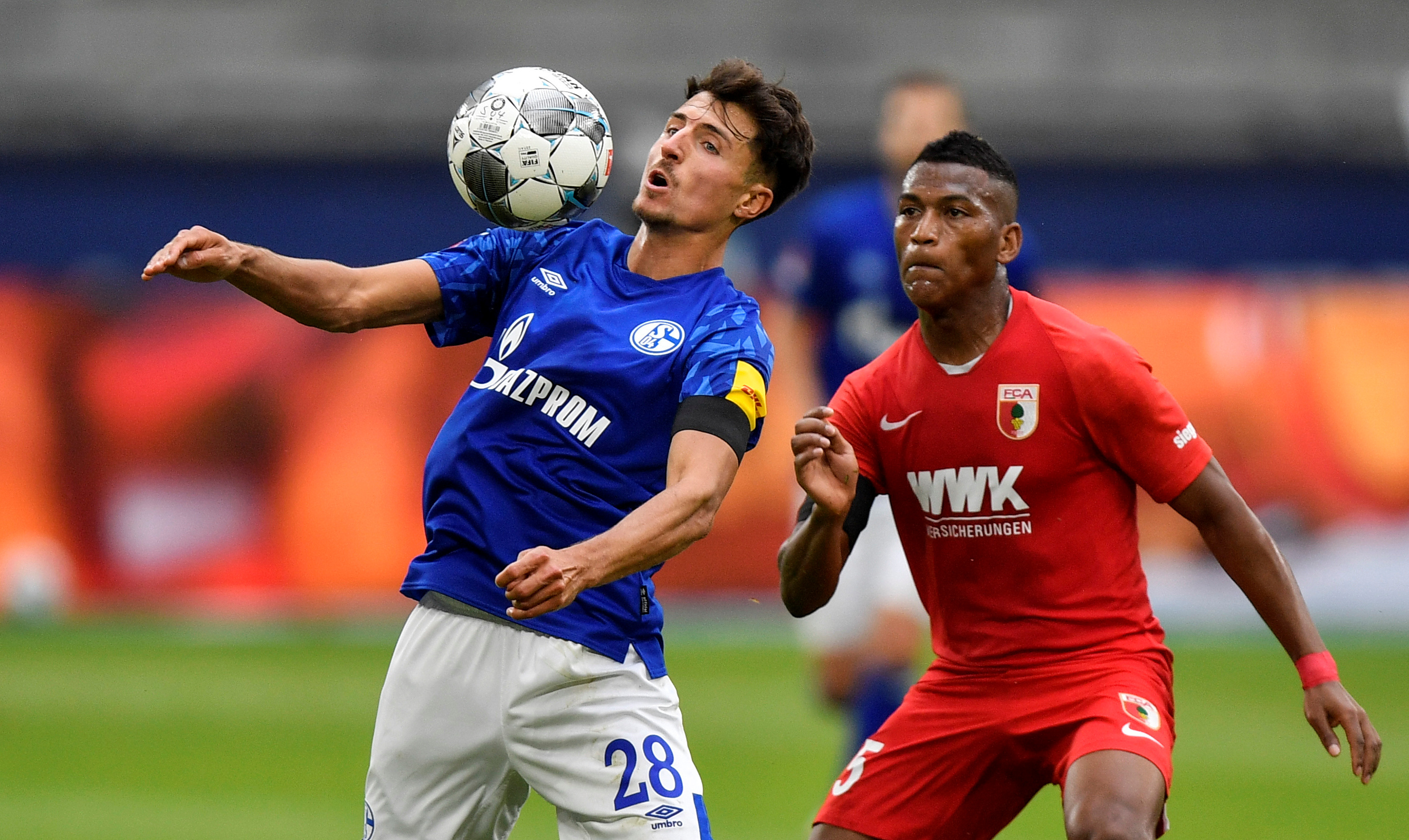 Schalke 04's Alessandro Schopf in action with FC Augsburg's Carlos Gruezo, as play resumes behind closed doors following the outbreak of the coronavirus disease (COVID-19) during the Bundesliga match between Schalke 04 and FC Augsburg, at Veltins-Arena, in Gelsenkirchen, Germany, on May 24, 2020. Photo: Martin Meissner/Pool via Reuters