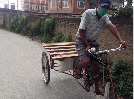 A daily wage earner riding his cycle cart to reach his destination, at Gatthaghar, Kathmandu, on Wednesday. Photo: THT