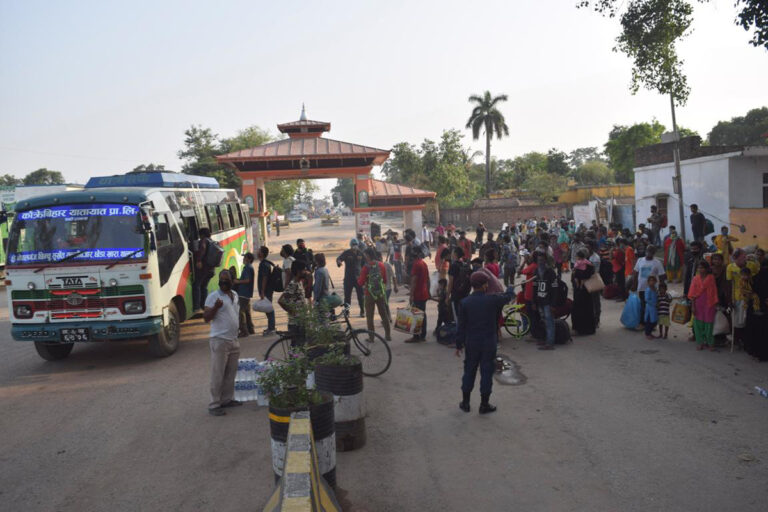 Nepalis entering the country from Jamunaha border point in Banke, being sent to their respective  destinations via bus, in Nepalgunj, on May 26, 2020. Photo: Tilak Gaunle/THT