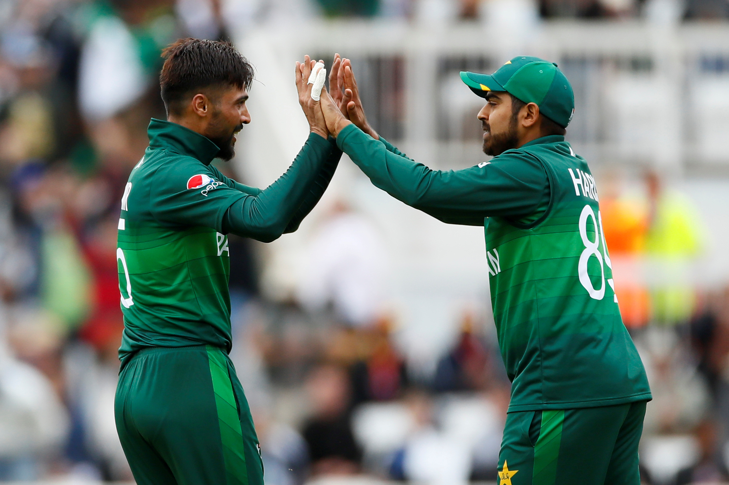 FILE PHOTO: Cricket - ICC Cricket World Cup - West Indies v Pakistan - Trent Bridge, Nottingham, Britain - May 31, 2019   Pakistan's Mohammad Amir celebrates with Haris Sohail after taking the wicket of West Indies' Chris Gayle    Action Images via Reuters/Jason Cairnduff/File Photo