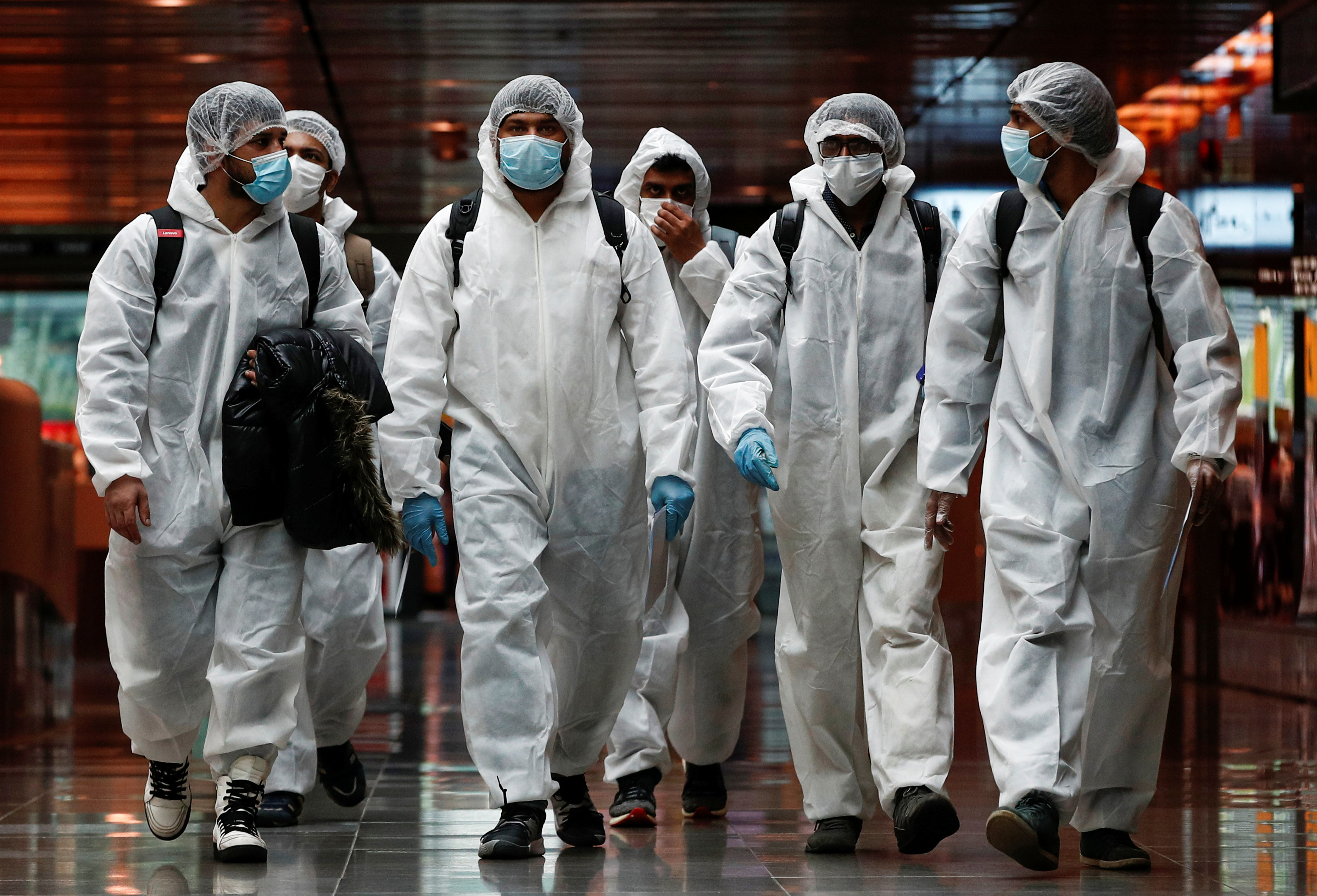Seafarers who have spent the past months working onboard vessels arrive at the Changi Airport to board their flight back home to India during a crew change amid the coronavirus disease (COVID-19) outbreak in Singapore June 12, 2020. REUTERS/Edgar Su