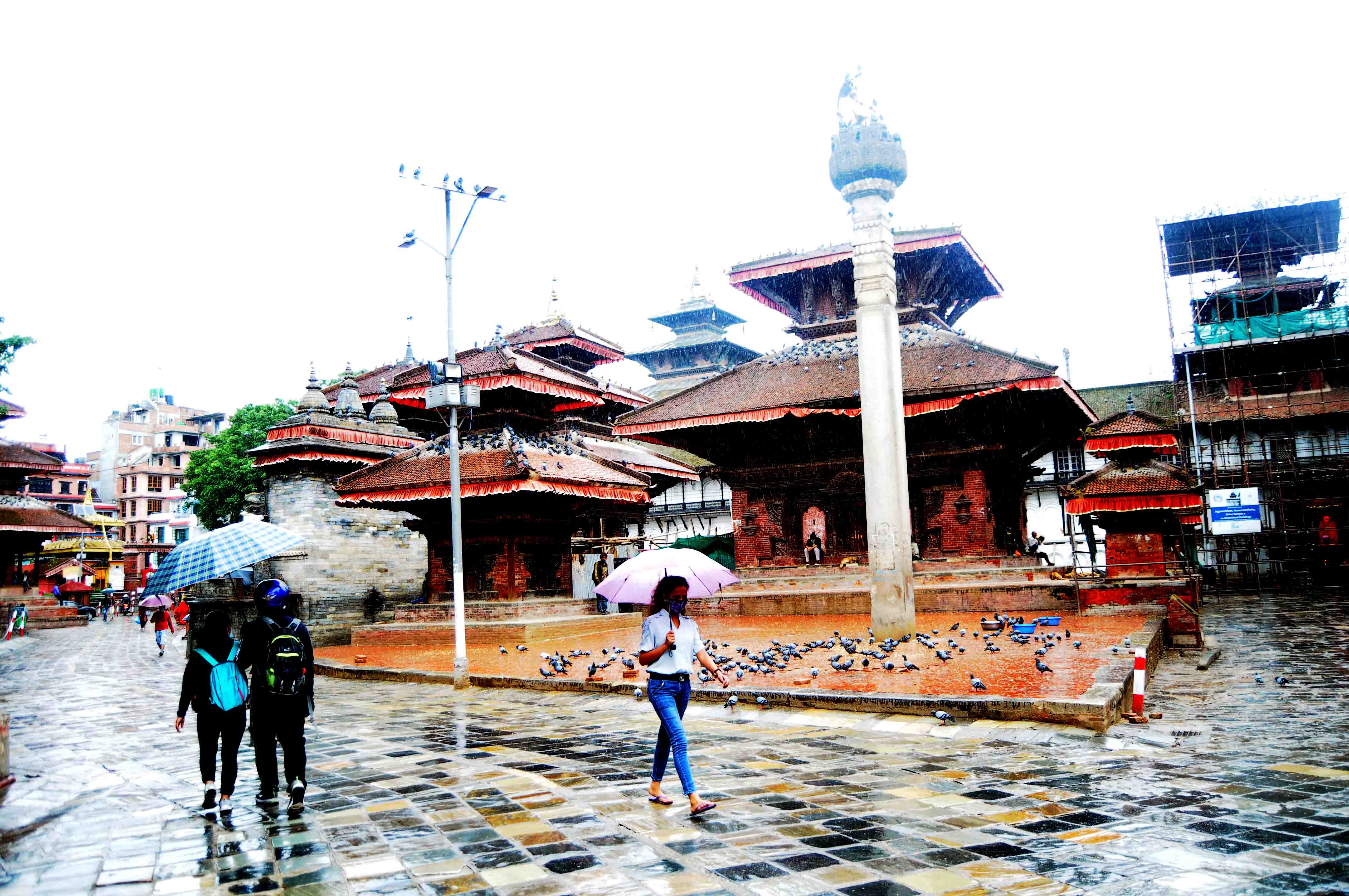 People go out and about on a rainy day, under their umberellas, at Hanumandhoka in kathmandu on Sunday. Photo: Balkrishna Thapa Chhetri/THT