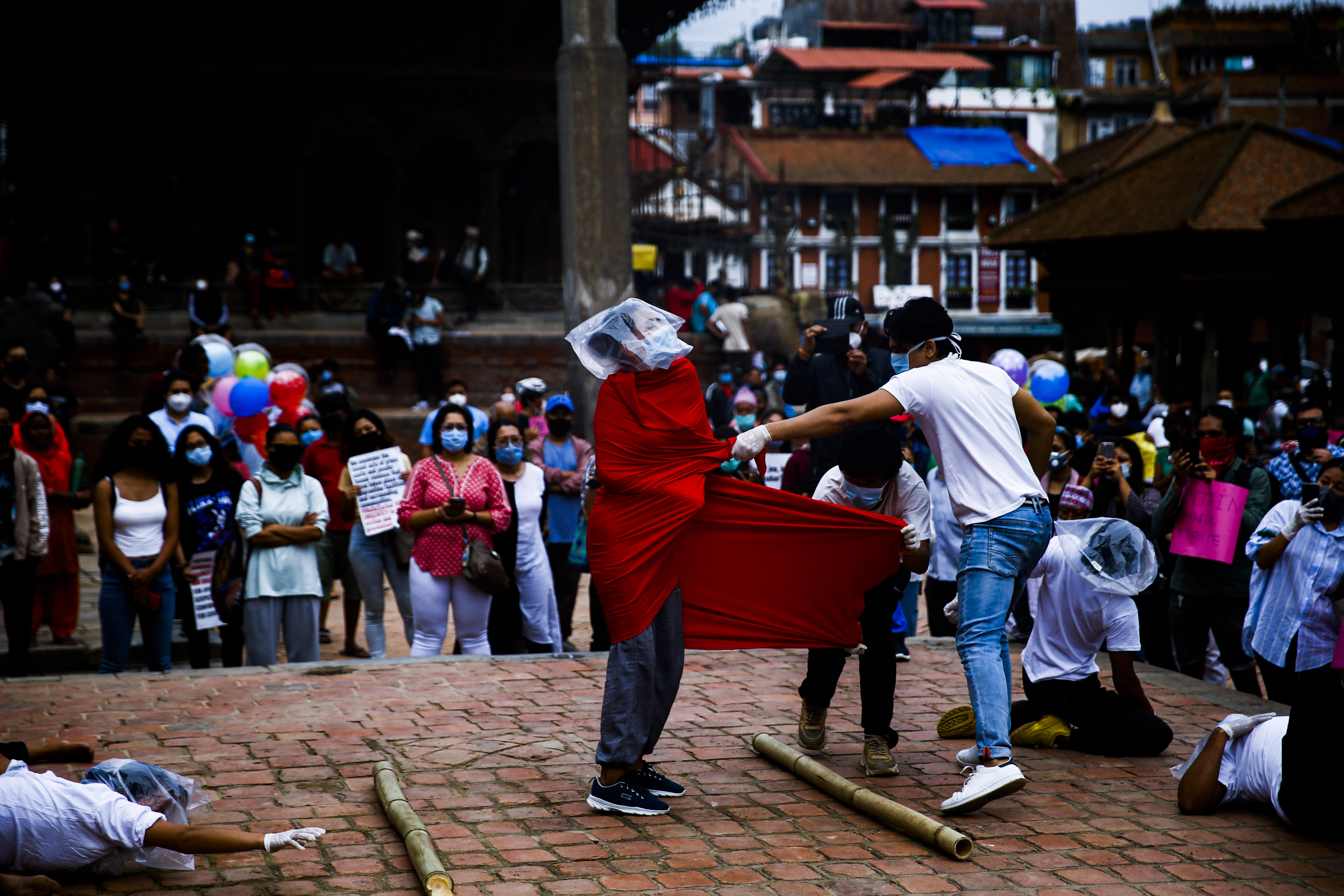 Youths stage a street performance during a symbolic protest against the incompetence displayed by the government in dealing with the coronavirus crisis at Patan Durbar Square in Lalitpur, Nepal on Tuesday, June 30, 2020. Photo: Skanda Gautam/THT