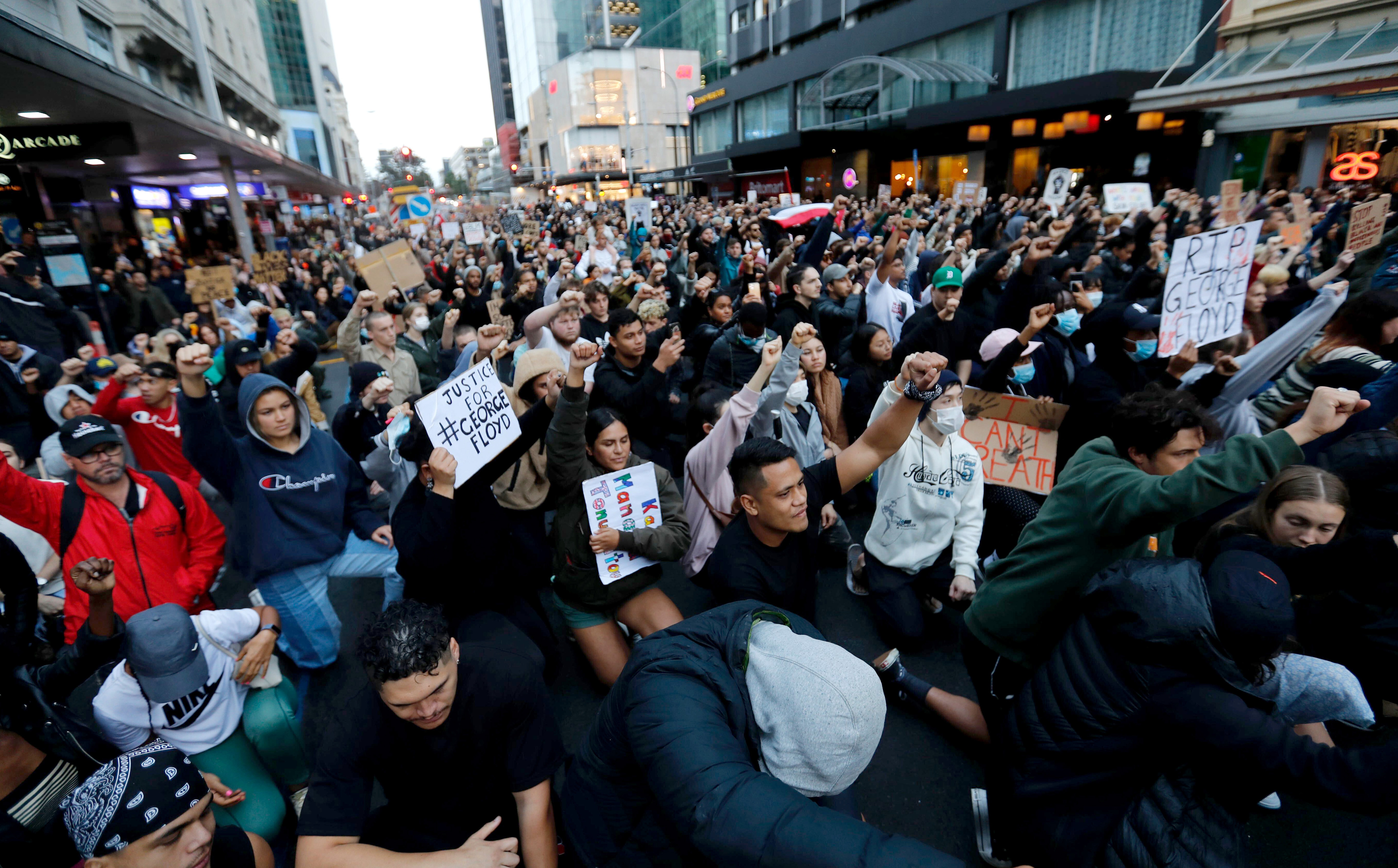 Demonstrators hold placards during a march in central Auckland, New Zealand, Monday, June 1. 2020, to protest the death of United States' George Floyd, a black man who died in police custody in Minneapolis on May 25. Floyd, who after a white police officer who is now charged with murder, Derek Chauvin, pressed his knee into Floyd's neck for several minutes even after he stopped moving and pleading for air. Photo: AP