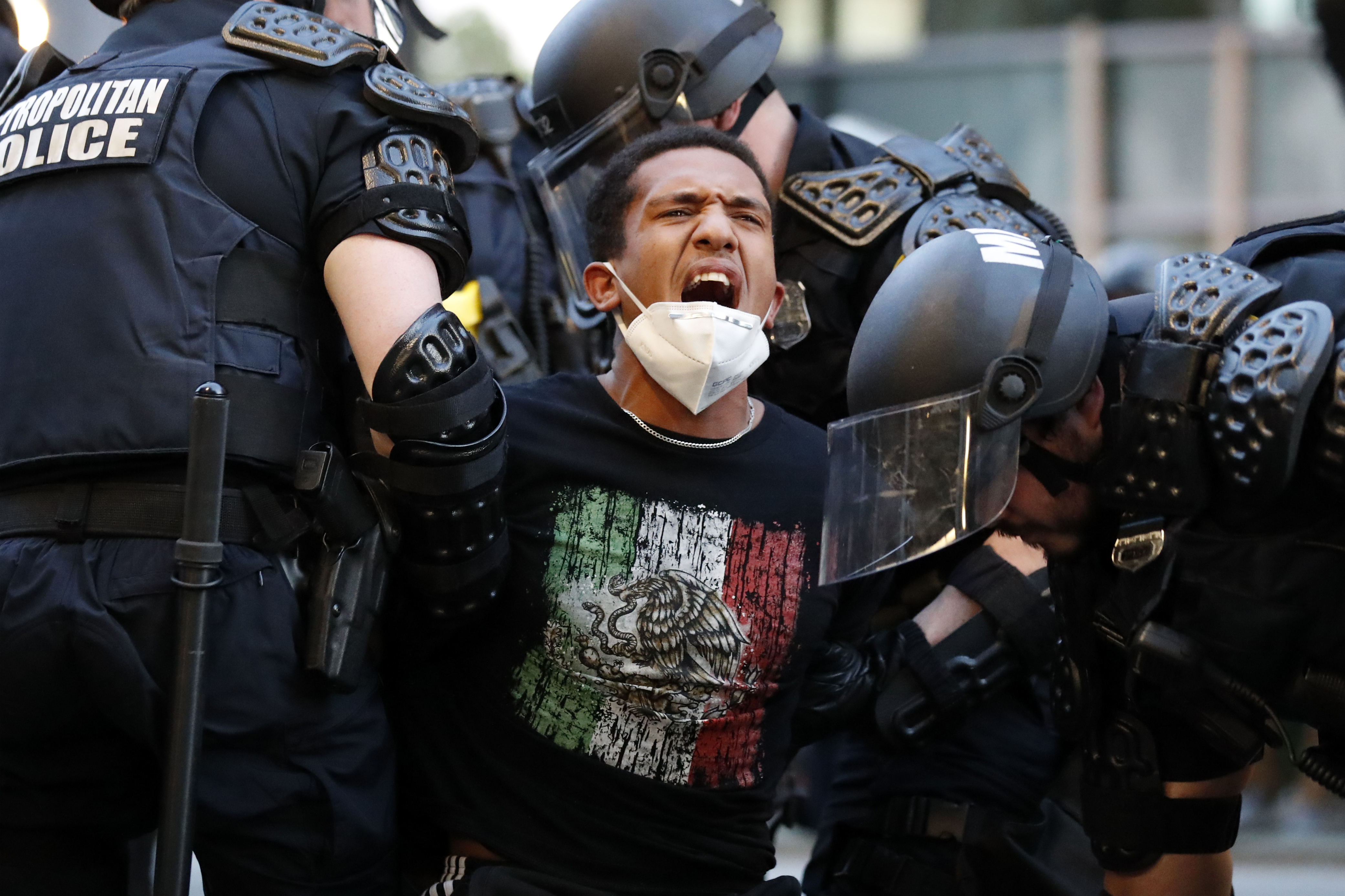 A demonstrator is taken into custody by police after a curfew took effect during a protest over the death of George Floyd, Monday, June 1, 2020, near the White House in Washington. Floyd died after being restrained by Minneapolis police officers. Photo: AP