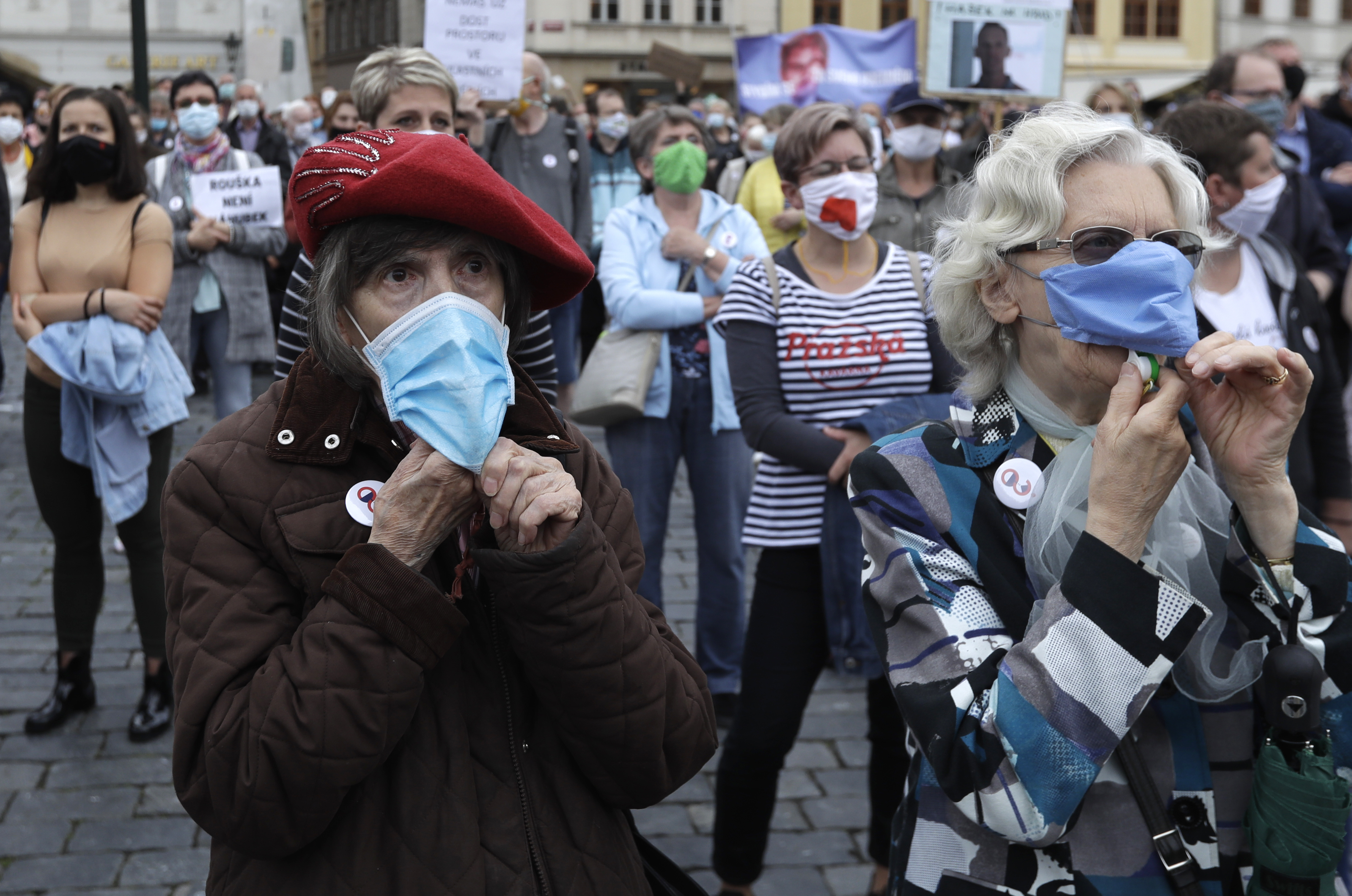 Elderly women wearing face masks to protect against coronavirus, blow whistles, during a protest at the Old Town Square in Prague, Czech Republic, Tuesday, June 9, 2020. Hundreds of people protested in the Czech capital to draw attention to the government's insufficient and chaotic response to the coronavirus outbreak and other financial issues. Photo: AP