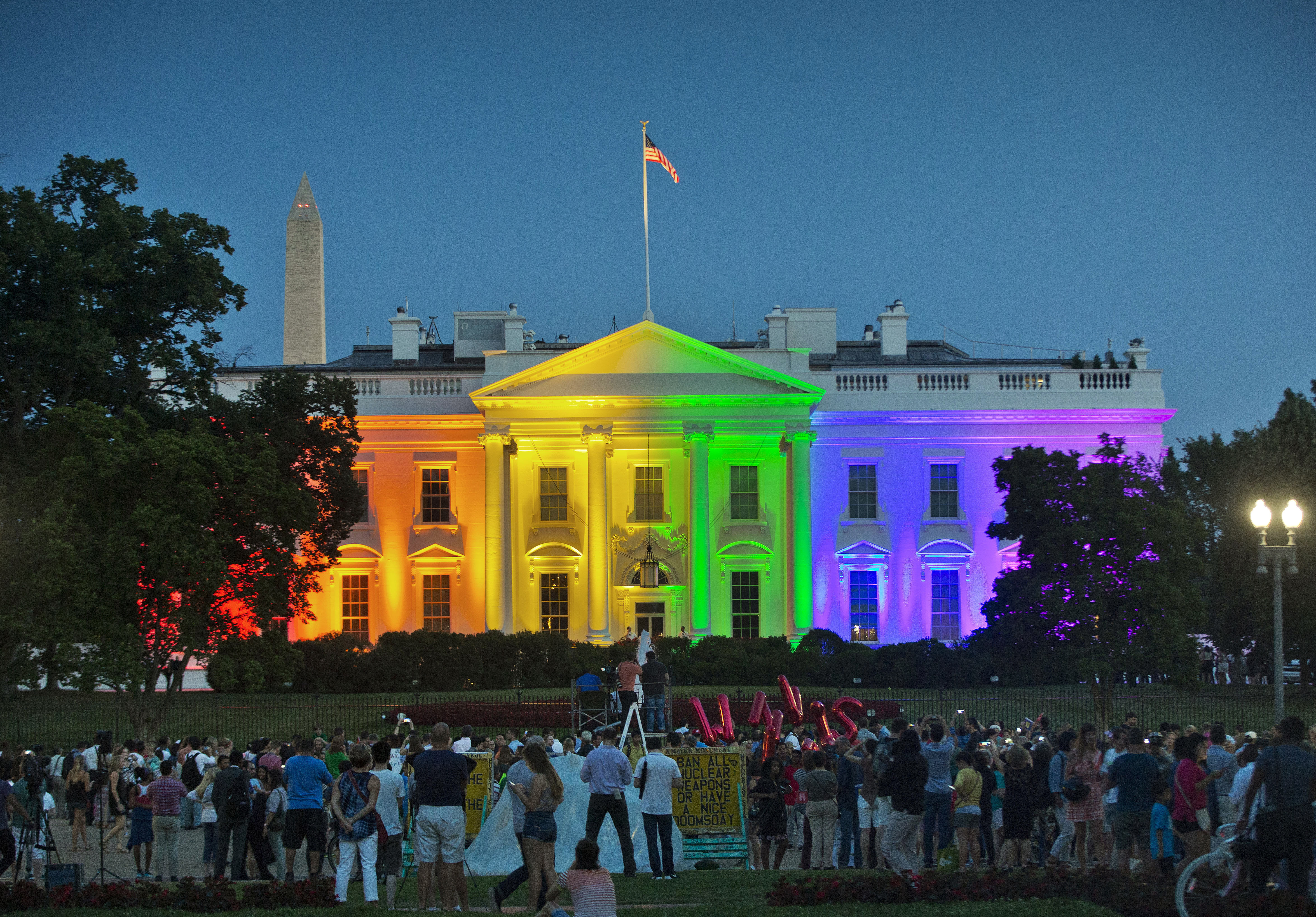 FILE - In this Friday, June 26, 2015 file photo, people gather in Lafayette Park to see the White House illuminated with rainbow colors in commemoration of the Supreme Court's ruling to legalize same-sex marriage in Washington. The Trump administration Friday, June 12, 2020, finalized a regulation that overturns Obama-era protections for transgender people against sex discrimination in health care. Photo: AP