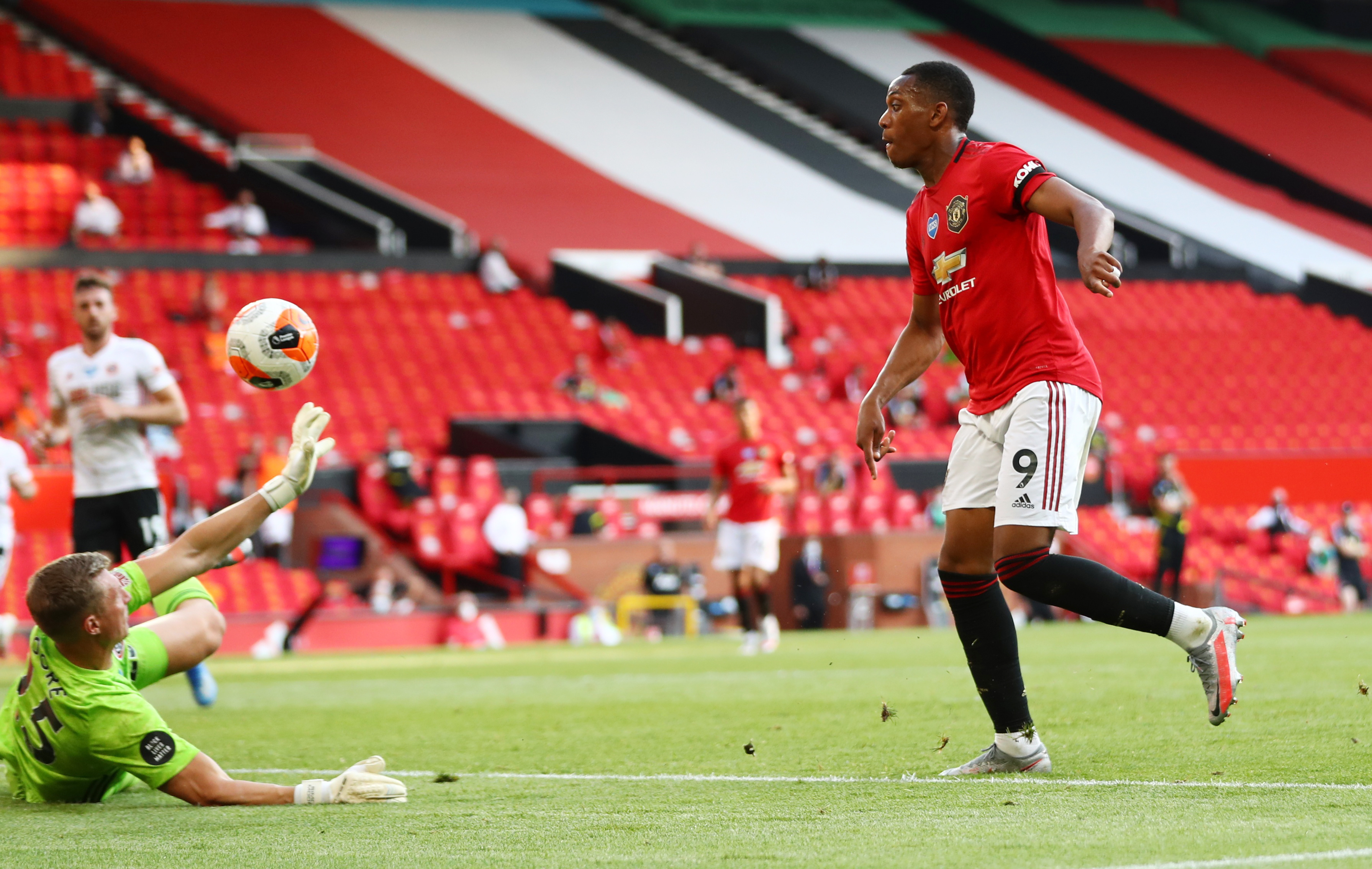 Manchester United's Anthony Martial scores their third goal to complete his hat-trick, as play resumes behind closed doors following the outbreak of the coronavirus disease (COVID-19)  during the Premier League match between Manchester United and Sheffield United, at Old Trafford, in Manchester, Britain, on June 24, 2020. Photo: Michael Steele/Pool via Reuters