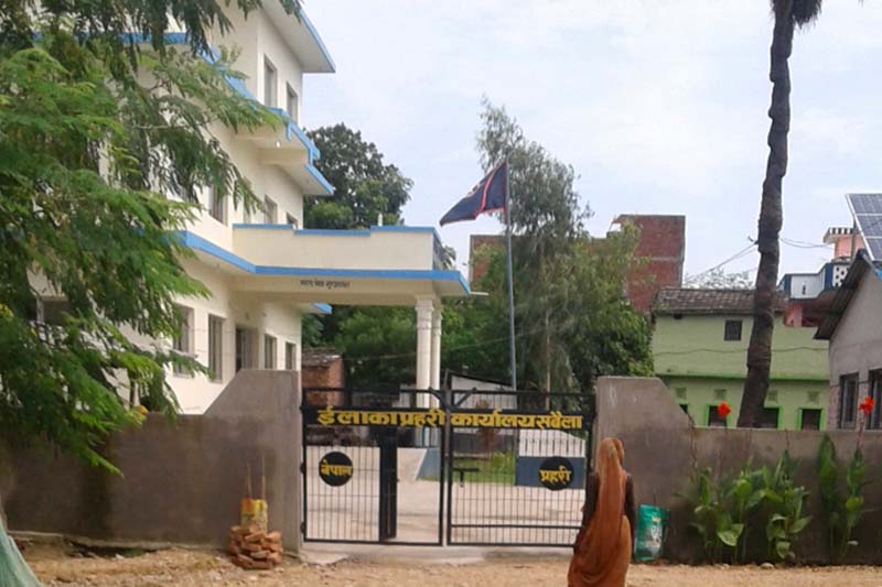 This image shows a woman walking in front of the entrance of Area Police Office in Sabaila Municipality, Dhanusha District, in August, 2017. Photo courtesy: Sanjiv Kumar Shah
