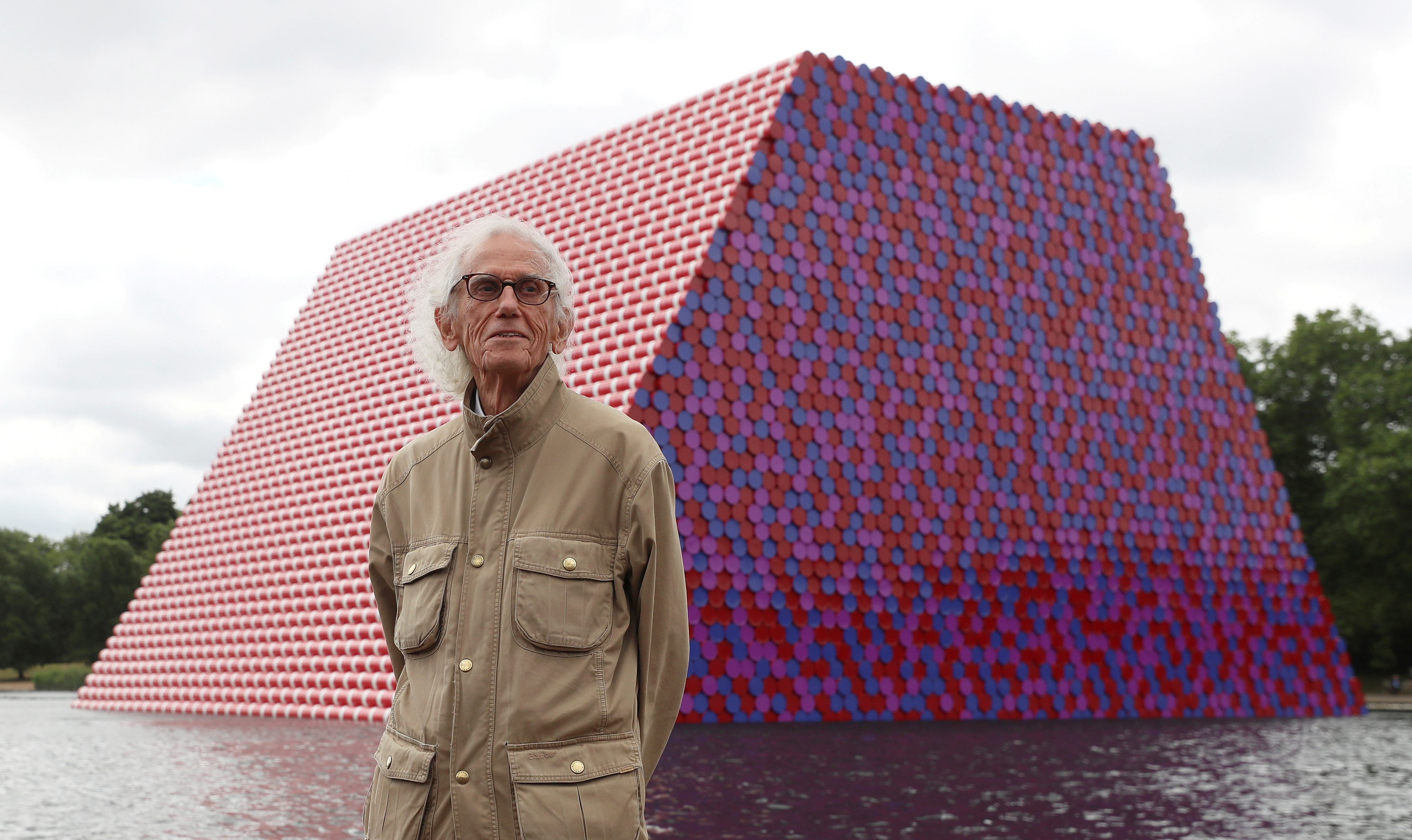 FILE -  Artist Christo stands in front of his work The London Mastaba, on the Serpentine in Hyde Park, London, Britain, June 18, 2018.  Photo: Reuters