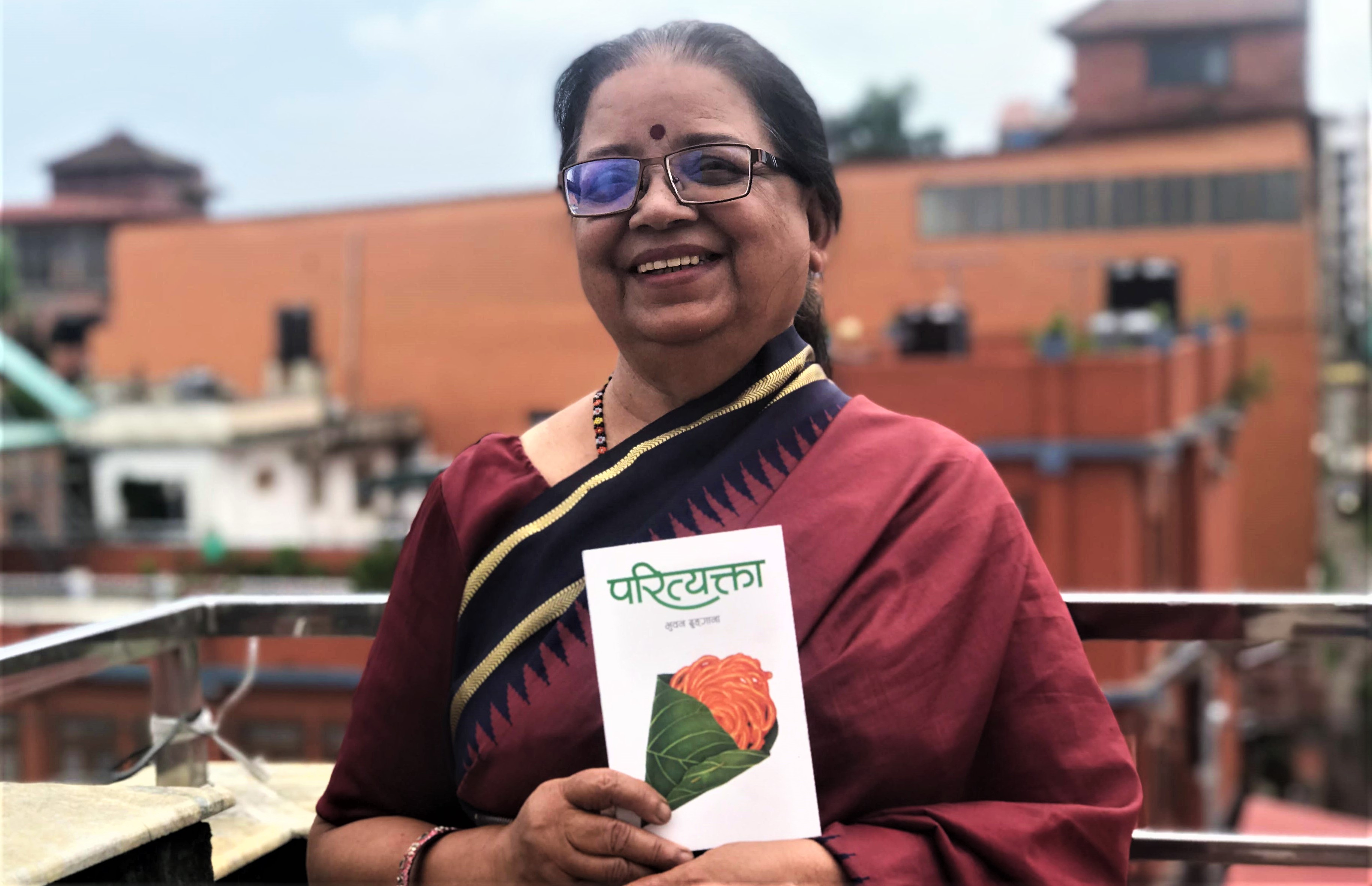 Author Bhuwan Dhungana with her book. Courtesy: Nepalaya